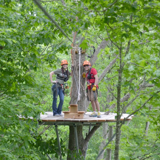 a man standing next to a tree