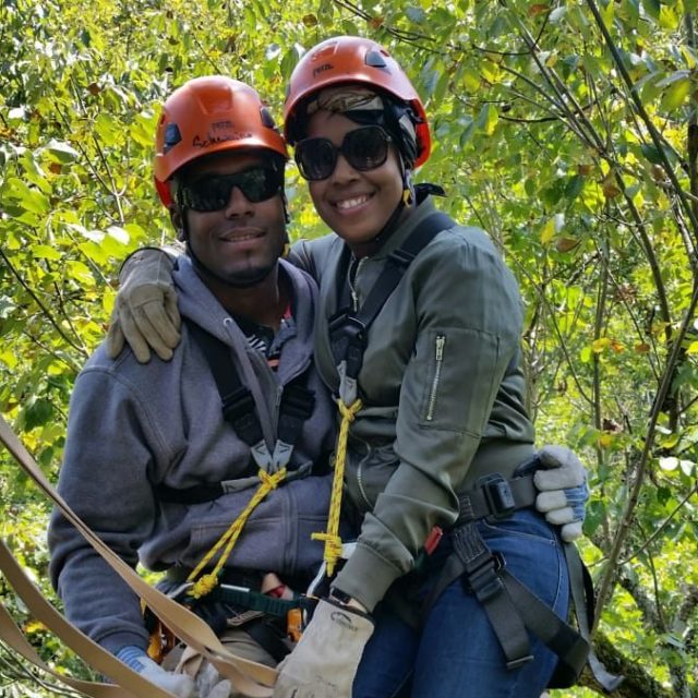 a couple of people that are sitting in a tree