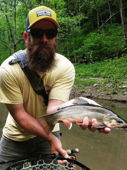 anglers-01 a man holding a fish in the water