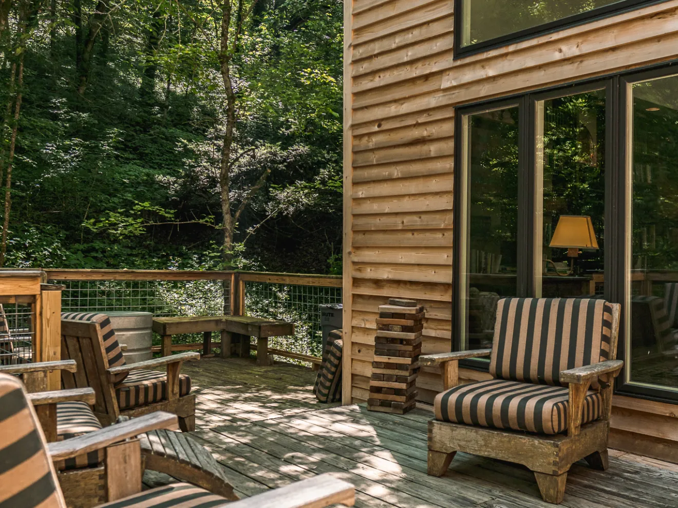 a wooden park bench sitting in front of a building