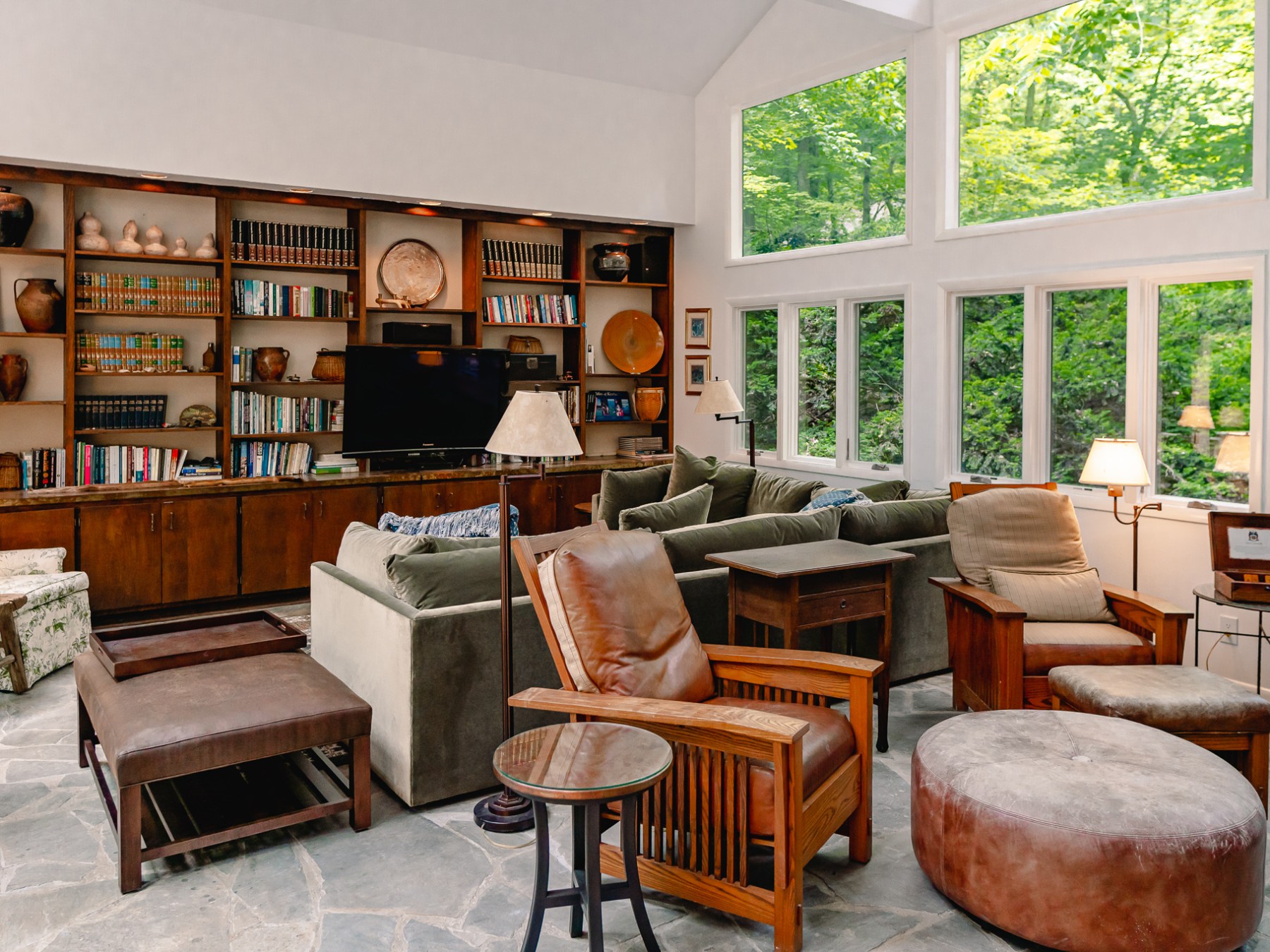 a living room filled with furniture and a large window