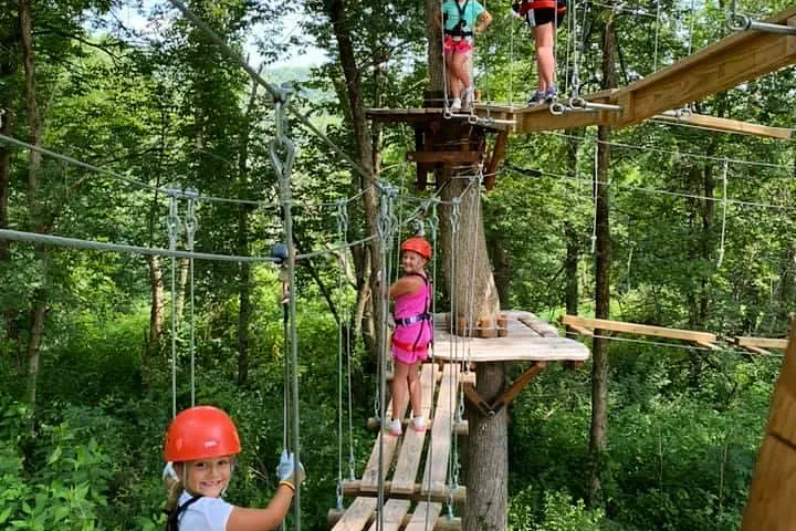 a person standing on top of a wooden fence