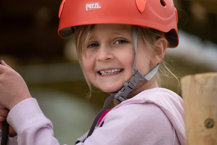 a little boy wearing a helmet holding a baseball bat
