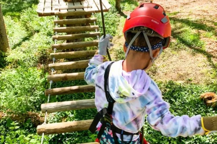 a child wearing a helmet holding a baseball bat