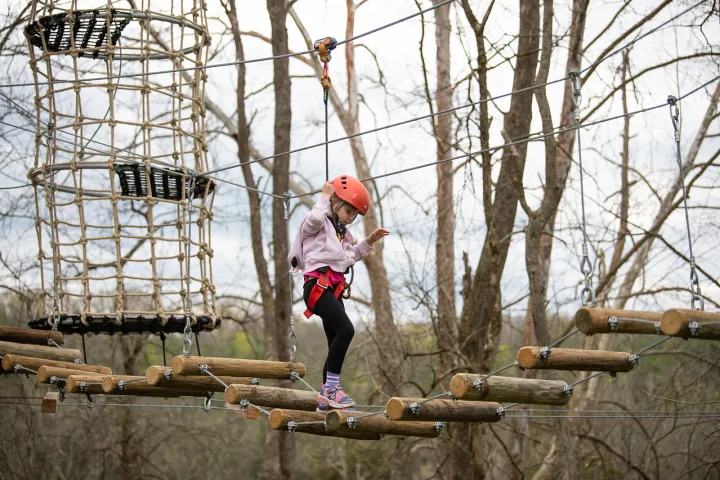 a person riding on the back of a wooden fence