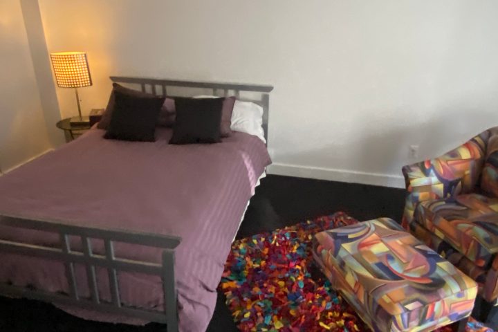 a bedroom with a bed in a room