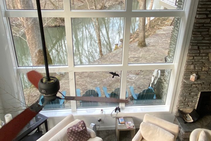 a living room filled with furniture and a large window