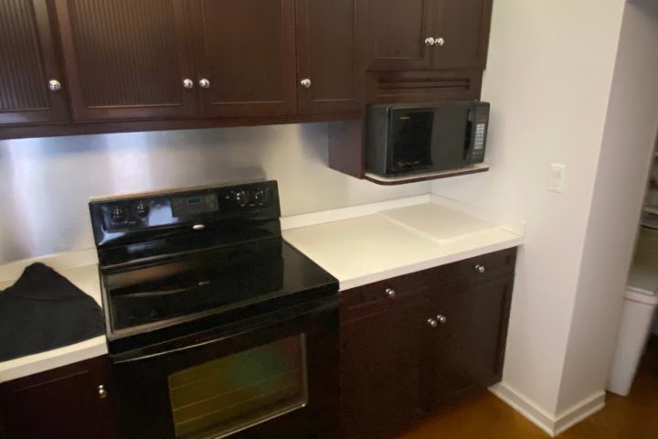 a stove top oven sitting inside of a kitchen