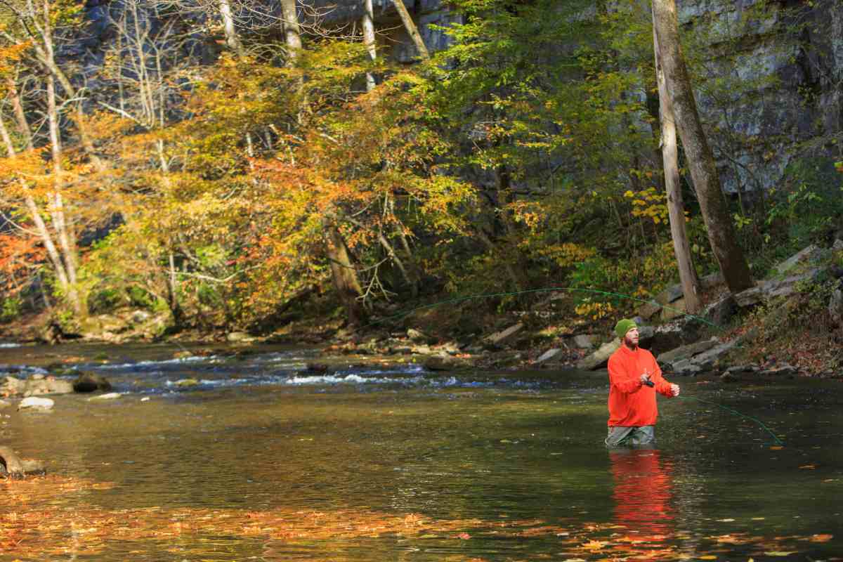 Photo by @wilkinsonvisual – www.wilkinsonvisual.com a person standing next to a lake
